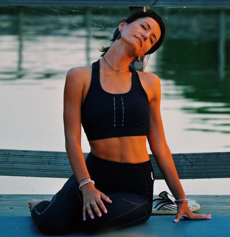 yoga girl; black sport bra; black leggings; premium activewear; comfort; medium support; lake view; after yoga relax; stretch;
